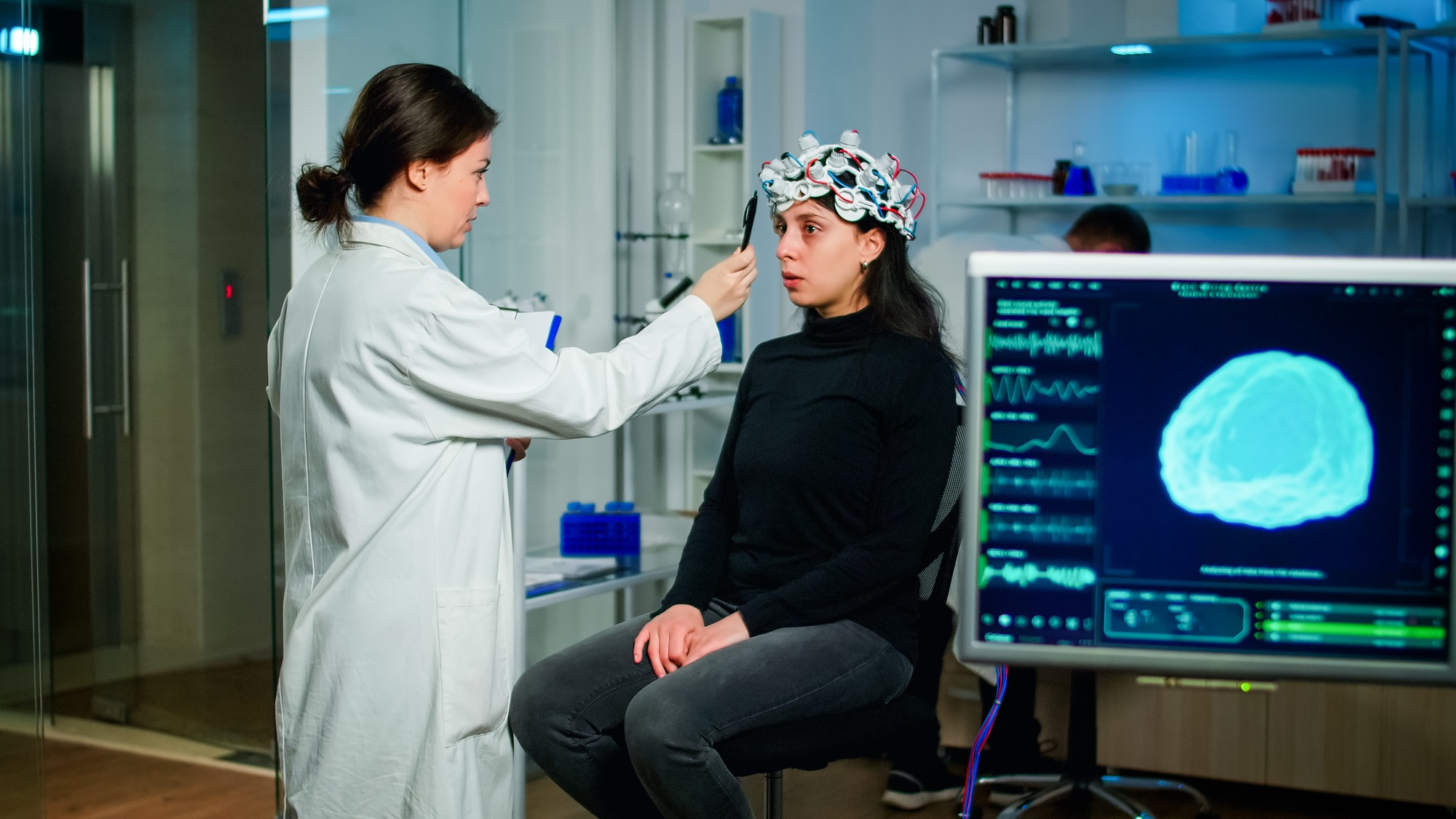 Medical researcher preparing patient for examining brain functions