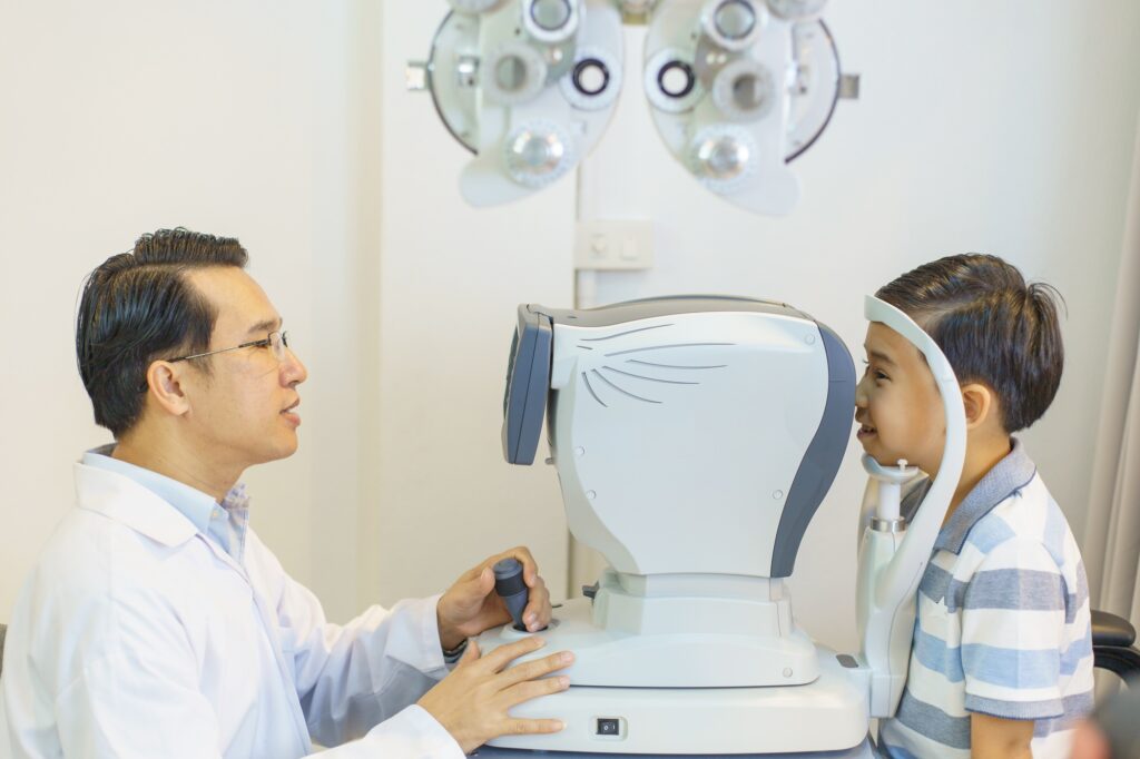 optometrists are examining pediatric patients' eyes with the Autorefractor